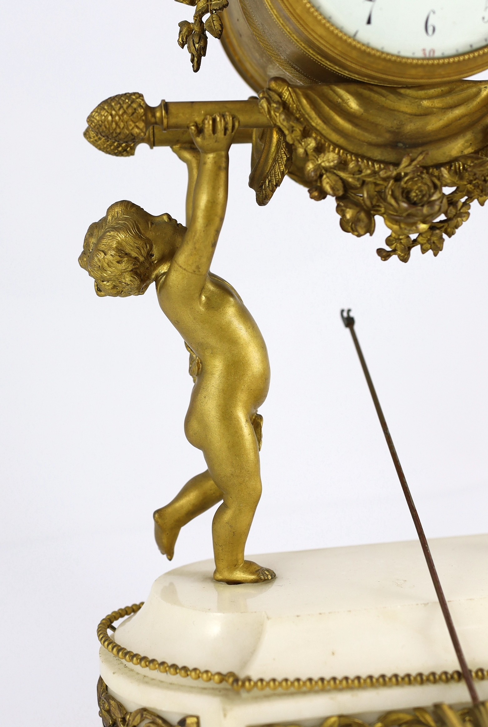 A French Louis XVI style ormolu and white marble mantel clock, 26cm wide, 48cm high